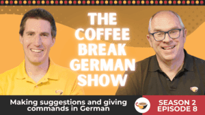 Two smiling male presenters in yellow and black polo shirts appear in front of a bright orange background with the title 'The Coffee Break German Show' in bold white text