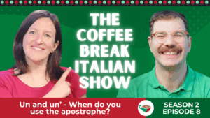 A woman pointing and smiling beside a man with glasses and a mustache, both in front of a green background.