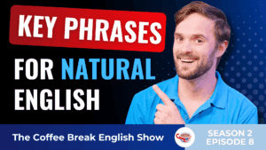 A smiling man in a blue shirt pointing to bold text that reads 'Key Phrases for Natural English'. The background is dark with a gradient and polka dot pattern.