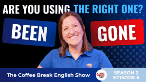 A smiling woman in a blue shirt, in a blue background.