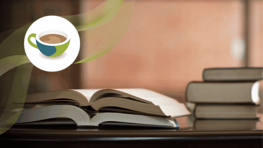 An open book on a wooden table with pages slightly curved, a stack of closed books in the background, and a blurred warm-toned setting.