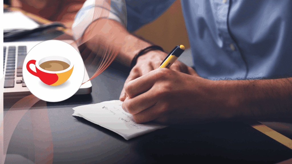 A person writing notes on paper beside a laptop, symbolising active language learning and study.