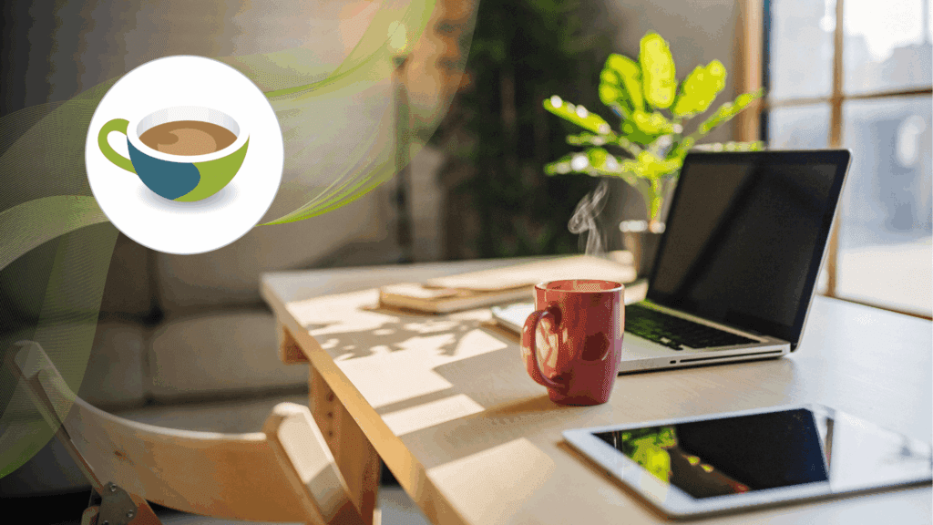 A cosy home workspace with a laptop, tablet, and a steaming red coffee mug on a wooden desk, with soft sunlight streaming through the window.